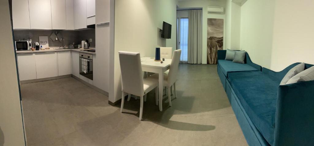 a kitchen and a dining room with a table and chairs at Isolotto Guest House in Porto Ercole