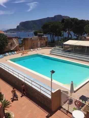 a large blue swimming pool on top of a building at Appartamento Ashur Mondello in Palermo