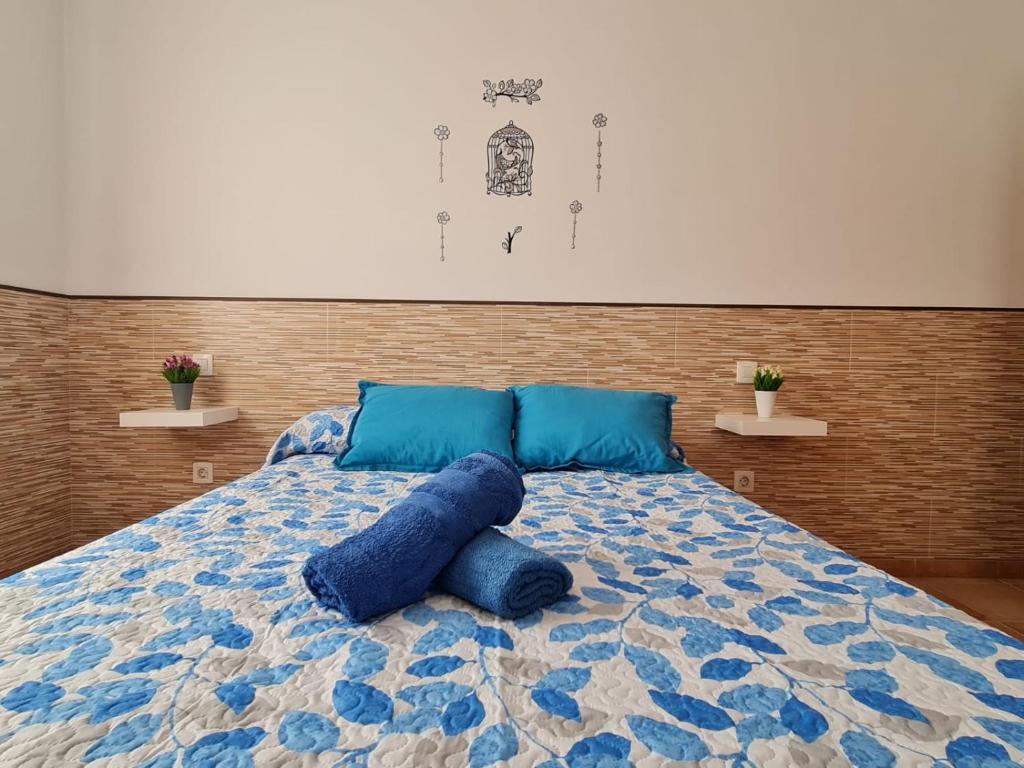 מיטה או מיטות בחדר ב-Casa ERIZO