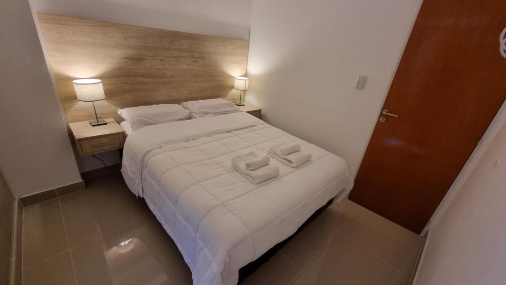 a bedroom with a bed with two towels on it at Hermoso departamento, excelente ubicación. in Salta