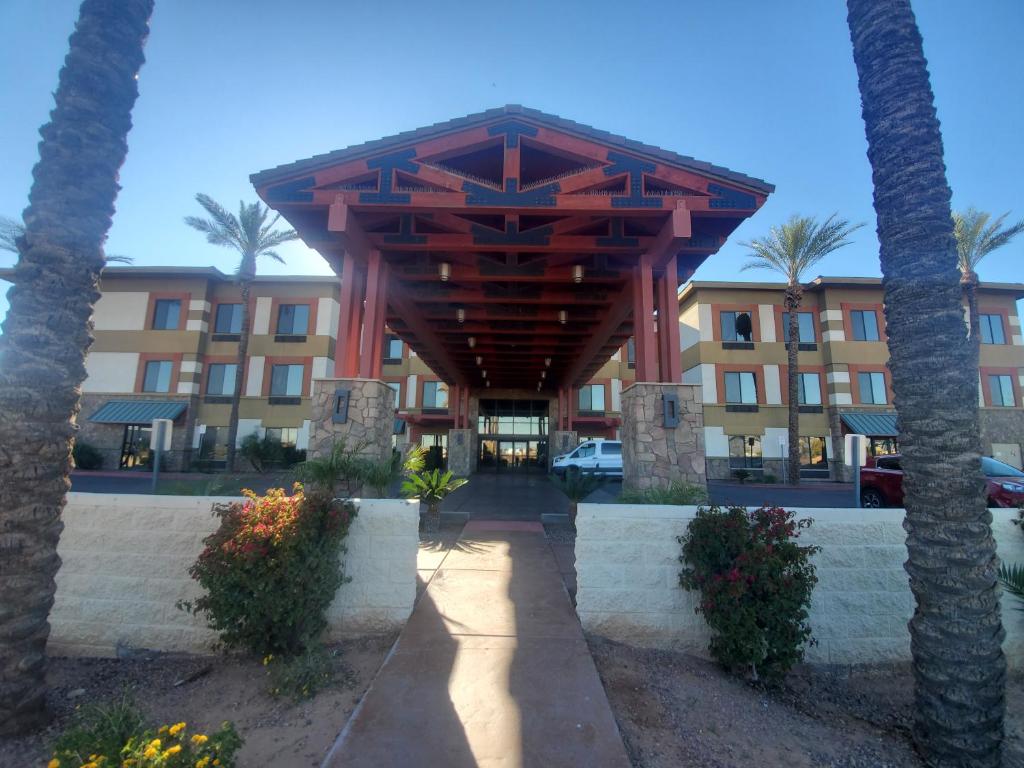 a hotel with a large wooden structure in front of a building at Legacy Inn & Suites in Mesa