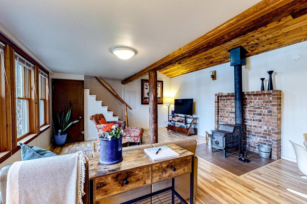 a living room with a couch and a fireplace at Seabeck Cottage on Hood Canal in Seabeck