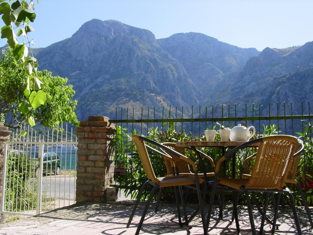 a table and chairs with a view of mountains at Apartment Mimosa in Kotor