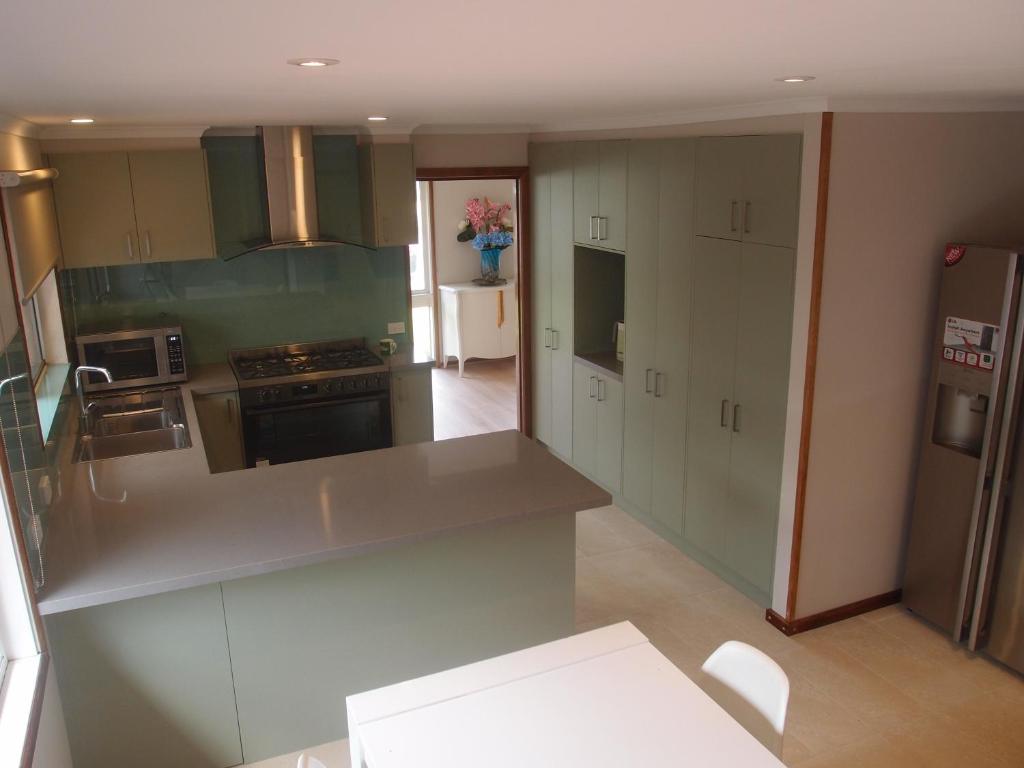 eine Küche mit einer Arbeitsplatte und einem Kühlschrank in der Unterkunft Corporate Share House in Melbourne