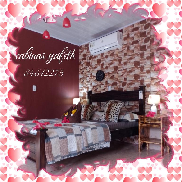a bedroom with a bed with hearts on the wall at yafeth Osa Room Drake Bay Longe in Drake