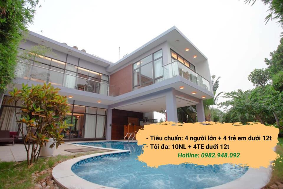 a house with a swimming pool in front of it at Bạch Yến T111-Happy Villa Flamingo Đại Lải Resort in Vĩnh Phúc