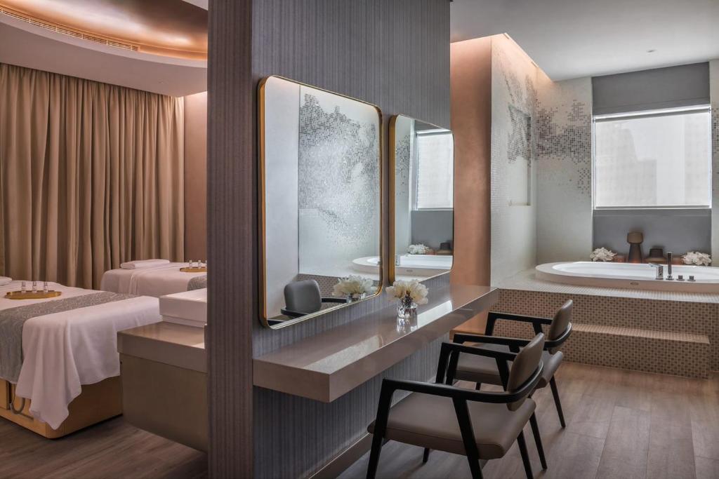 a hotel room with a bed and a bath tub at Paramount Hotel Midtown in Dubai