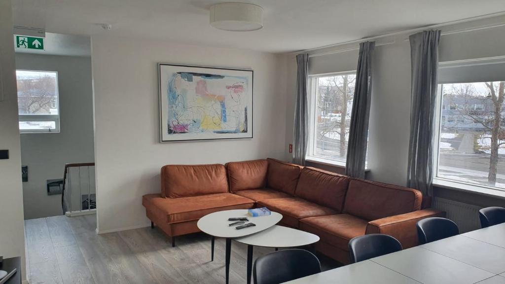 a living room with a couch and a table at Post-Plaza Guesthouse in Húsavík