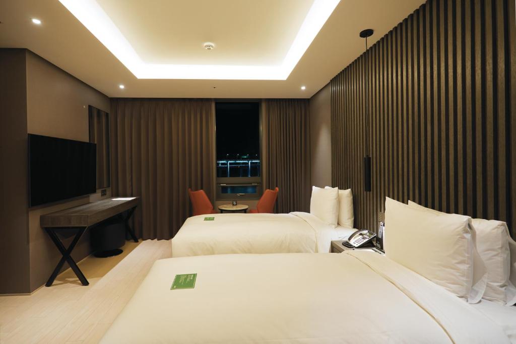 Postel nebo postele na pokoji v ubytování AG405 Hotel