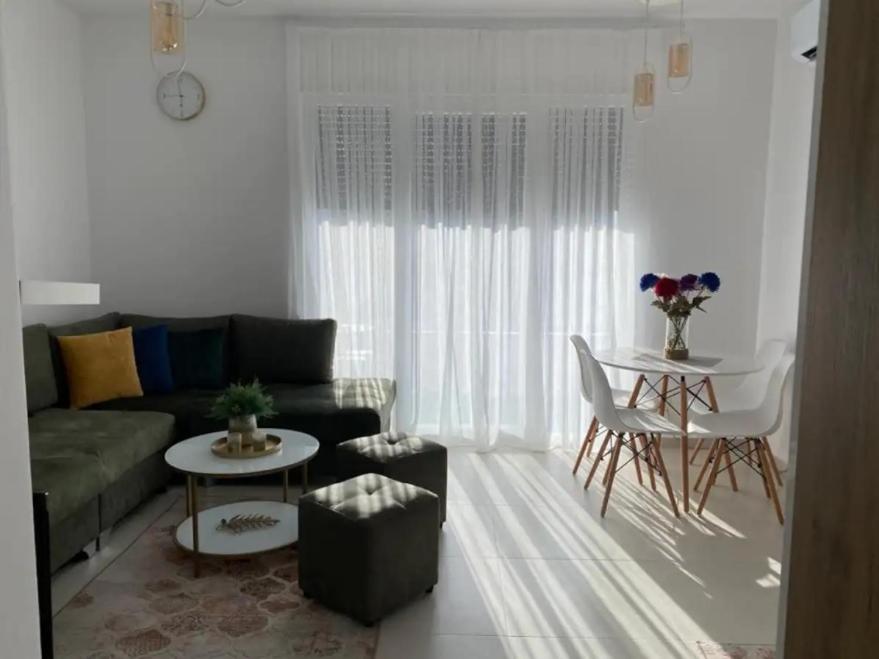 a living room with a couch and a table at Valamar ED Apartment in Hamallë