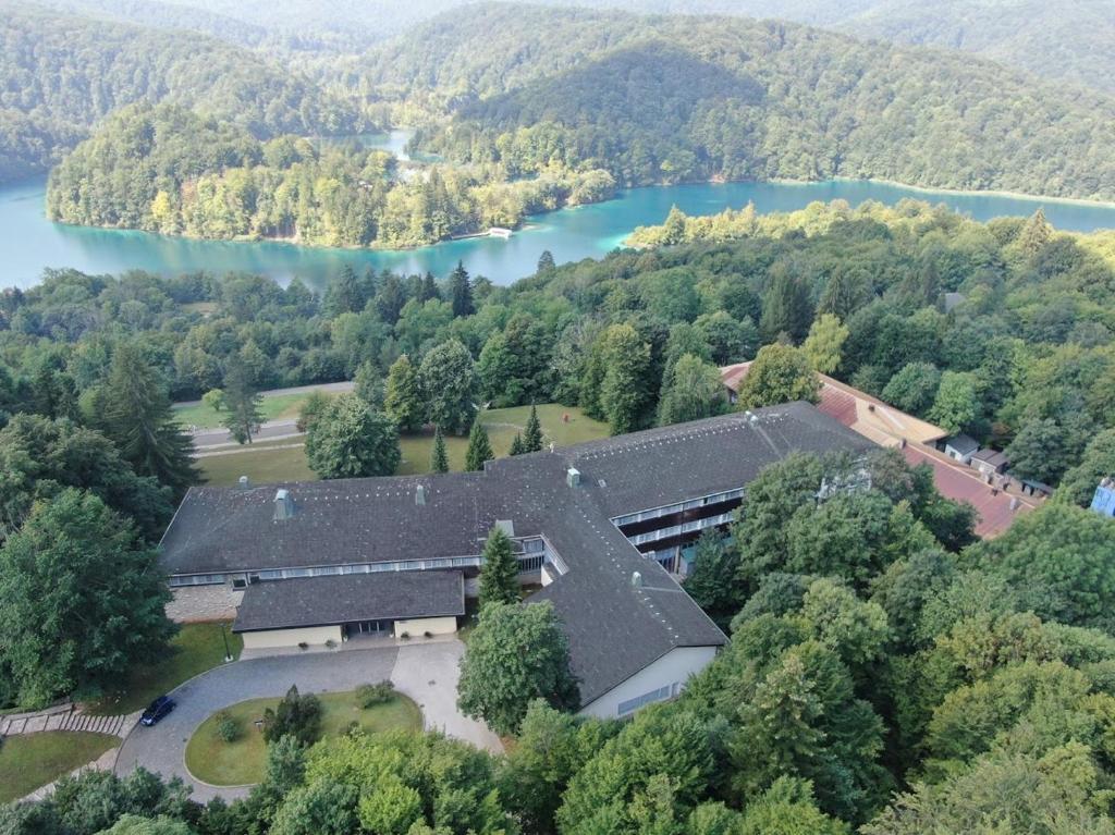 an aerial view of a building with a lake at Hotel Plitvice in Plitvička Jezera