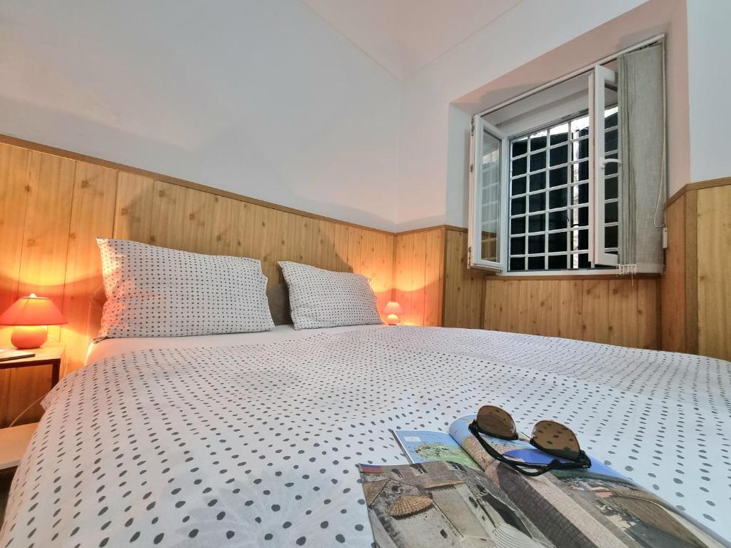 a bedroom with a large bed with a window at Studio Heart of the Town in Dubrovnik
