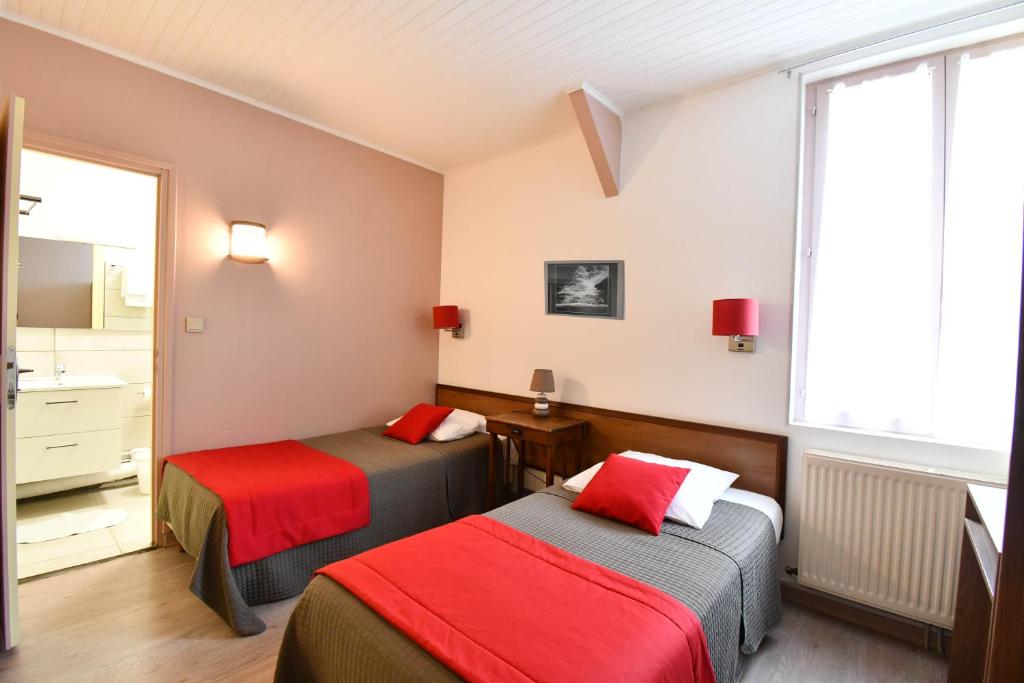 Postel nebo postele na pokoji v ubytování Hotel Fortin
