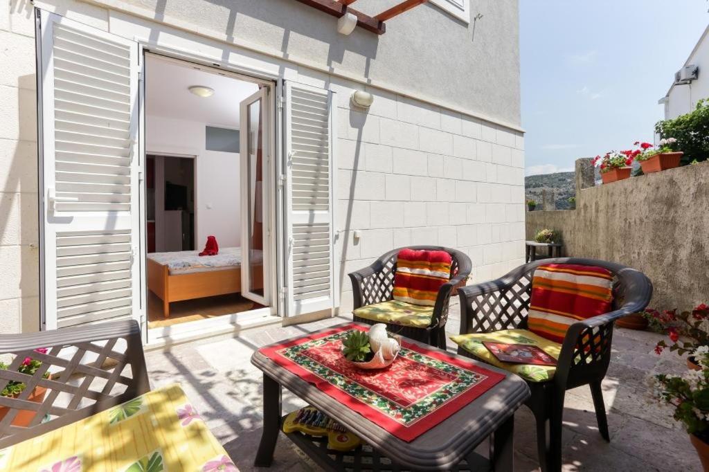 a patio with two chairs and a table on a balcony at Apartments Pojko in Dubrovnik