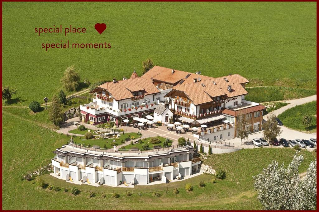 an aerial view of a large mansion with a heart at Hotel Amaten in Brunico