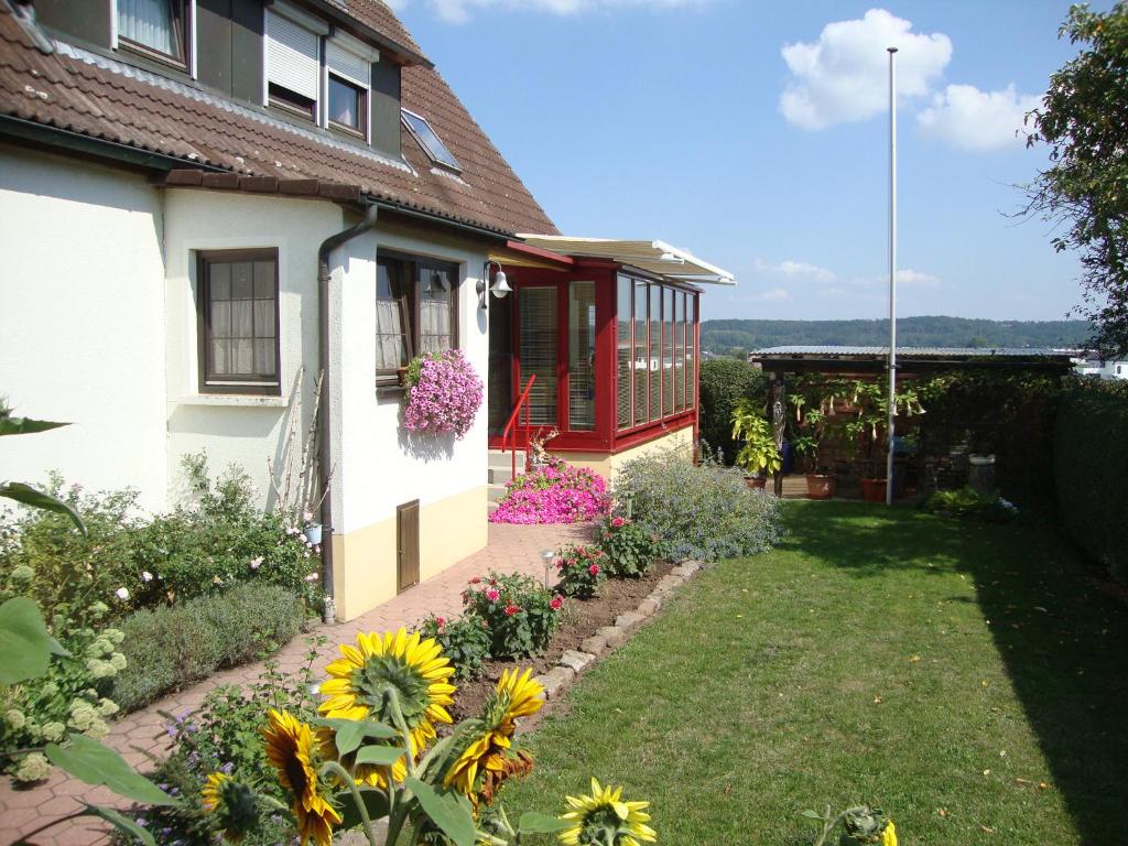 ein Haus mit einem Garten mit Blumen im Hof in der Unterkunft Haus Reif in Dombühl
