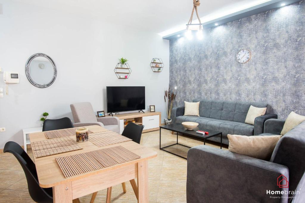 a living room with a couch and a table at Eva's House Project by Homebrain in Alexandroupoli