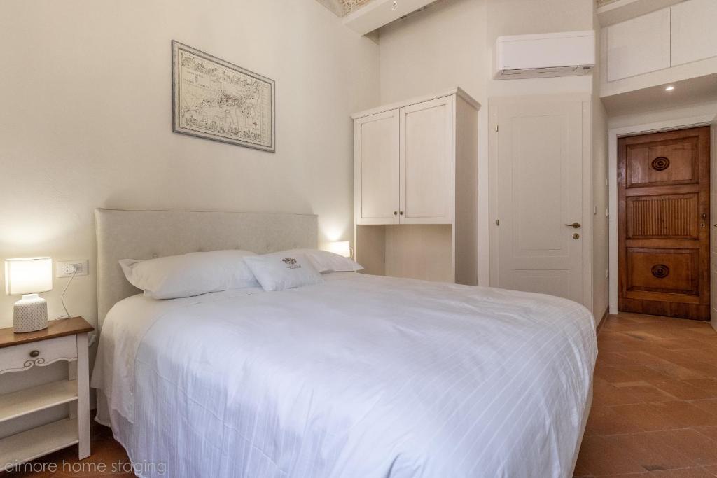 Łóżko lub łóżka w pokoju w obiekcie Casa Maghinardo