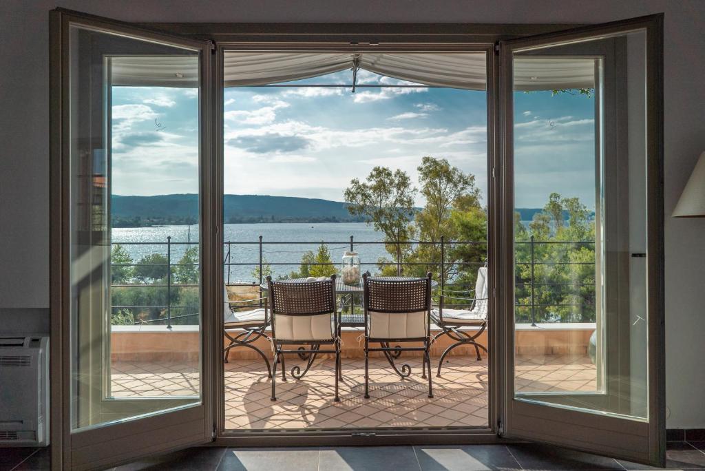 a room with sliding glass doors looking out onto a balcony at Jasmine by the sea - Κάτω Γατζέα, Πήλιο in Kato Gatzea