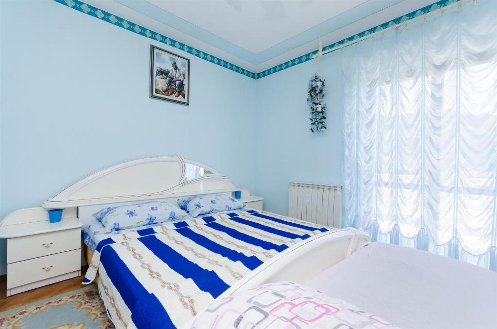 Postel nebo postele na pokoji v ubytování Apartments VESNA