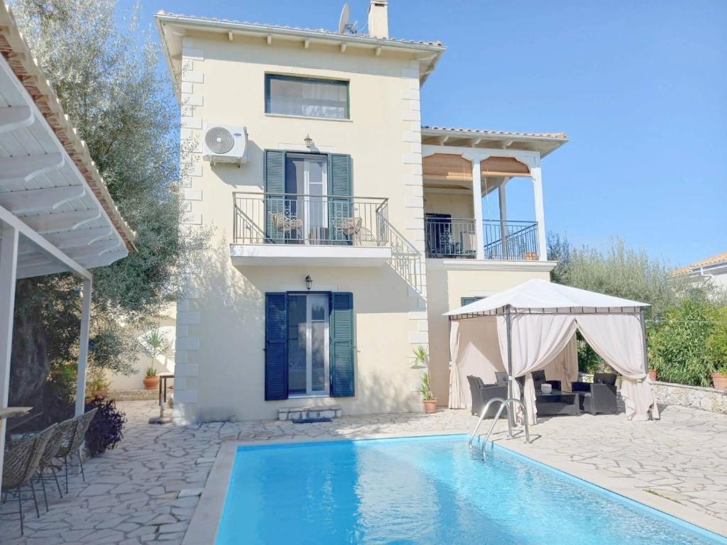a villa with a swimming pool and a house at My Lefkada Boutique Villa by Olga Lounge Hotel - Panoramic View - VISIT THE REAL PARADISE !!! in Lygia