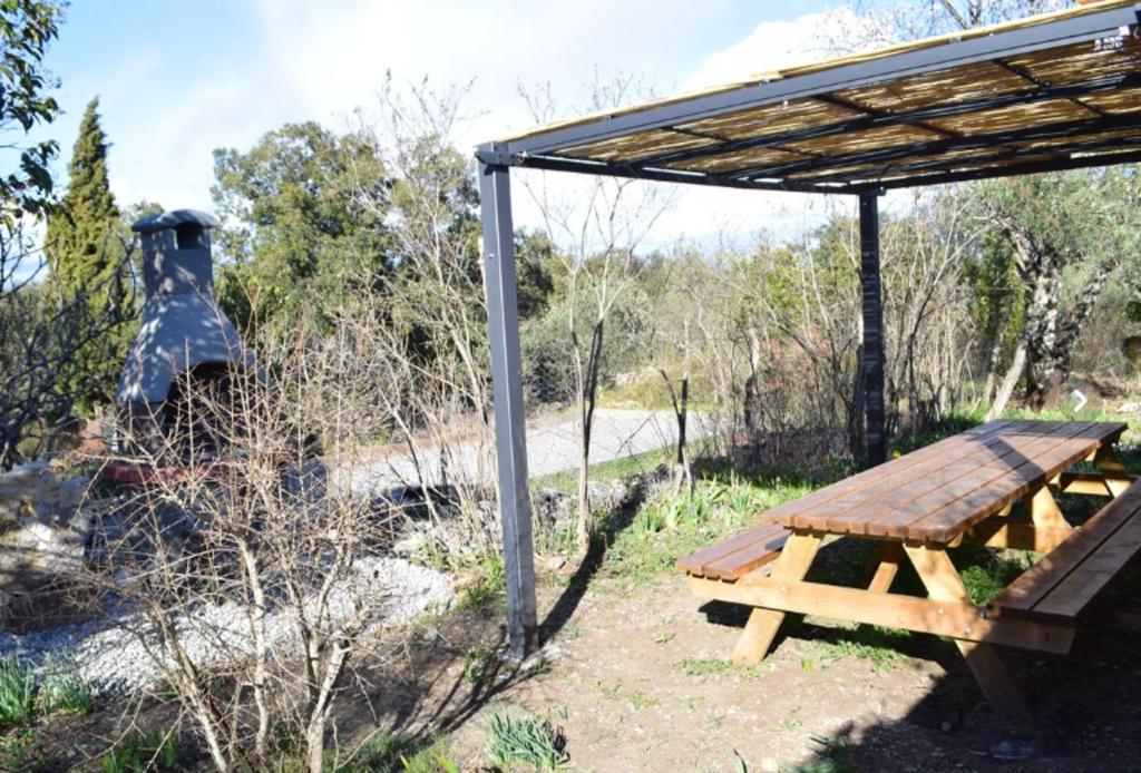 a picnic table under a shelter in a field at Maison de 5 chambres avec jardin amenage a Les Vans in Les Vans