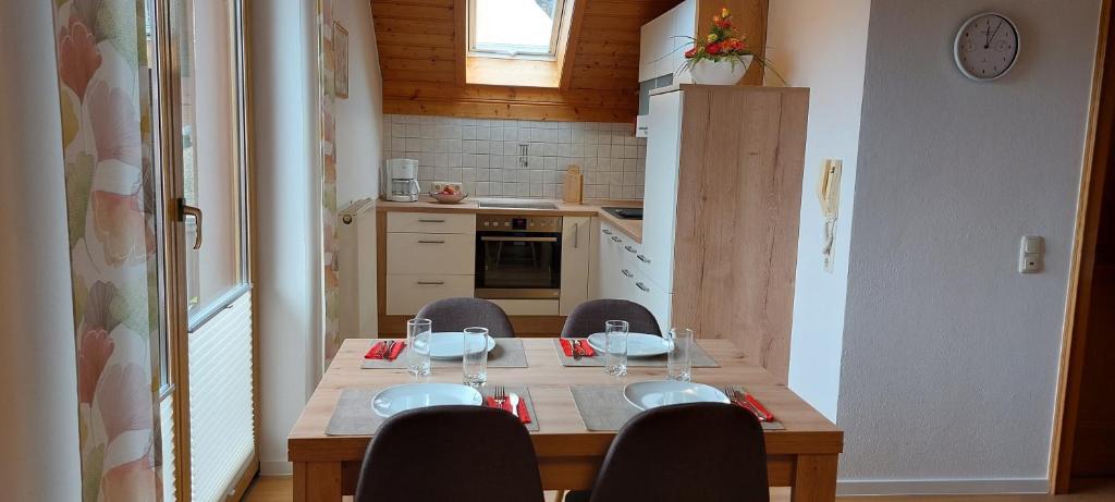 a kitchen with a wooden table with chairs and a dining room at Haus Johanna in Oberberging