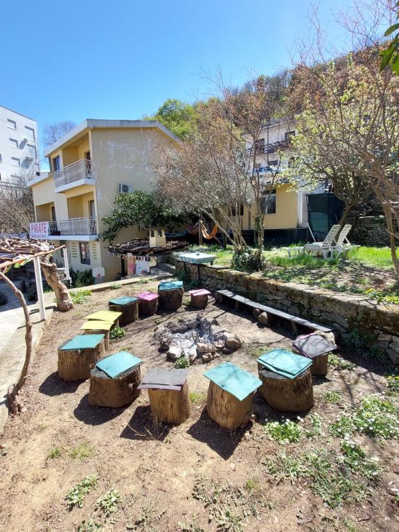 a patio area with chairs, tables, and lawn furniture at Hostel Pirate in Ulcinj