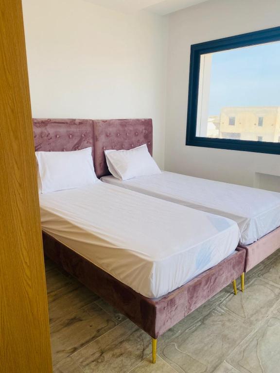 Un ou plusieurs lits dans un hébergement de l'établissement ULYSSE HOUSE-Djerba