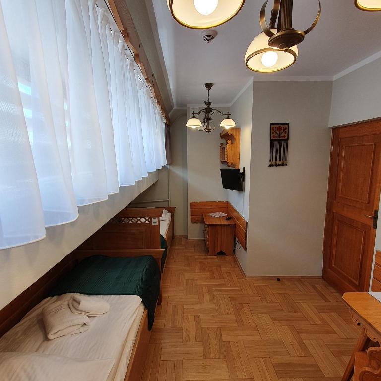 Posteľ alebo postele v izbe v ubytovaní Pokoje Gościnne Zakopane