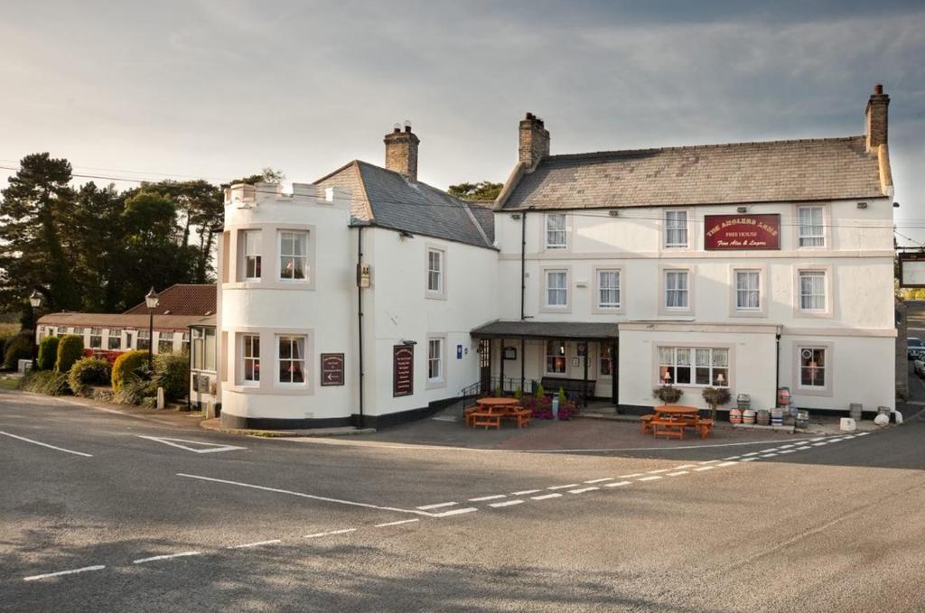 un gran edificio blanco al lado de una calle en Anglers Arms, en Alnwick