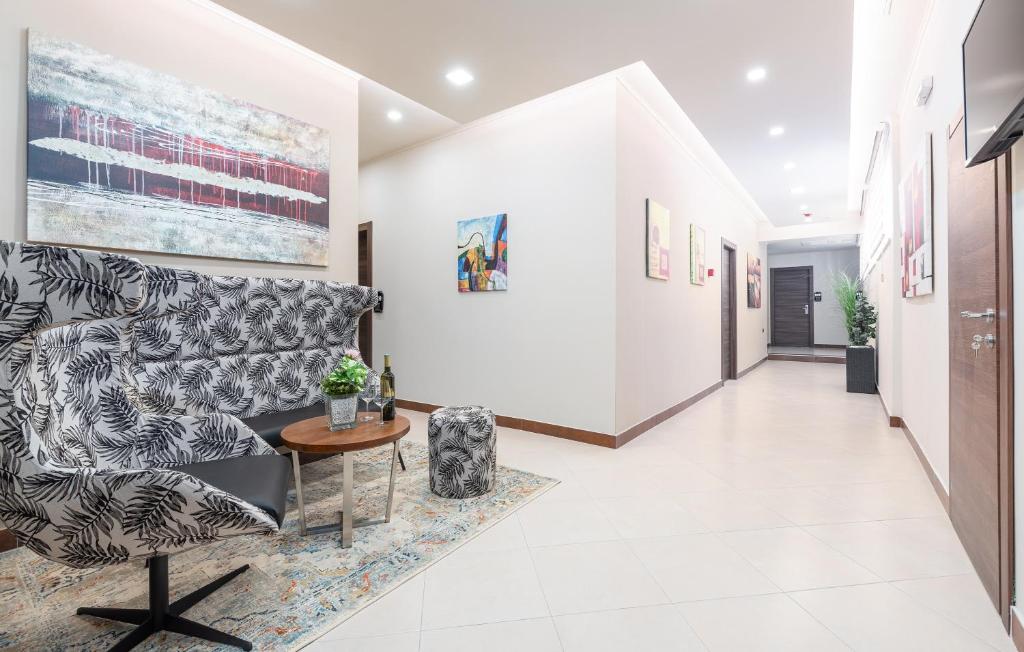 a hallway with a couch and a table at Hotel Dua Residence in Poreč