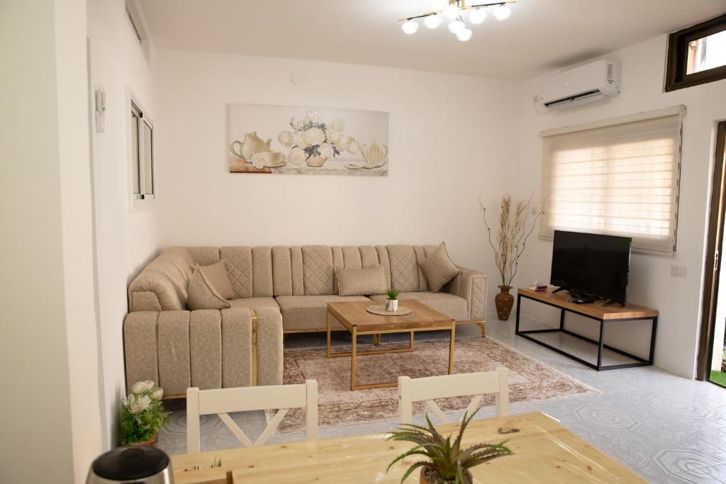 a living room with a couch and a table at רוזמרין בחרמון in Majdal Shams