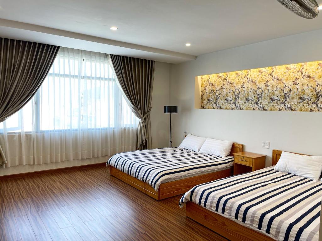 Postel nebo postele na pokoji v ubytování Tuan Long Da Lat Hostel
