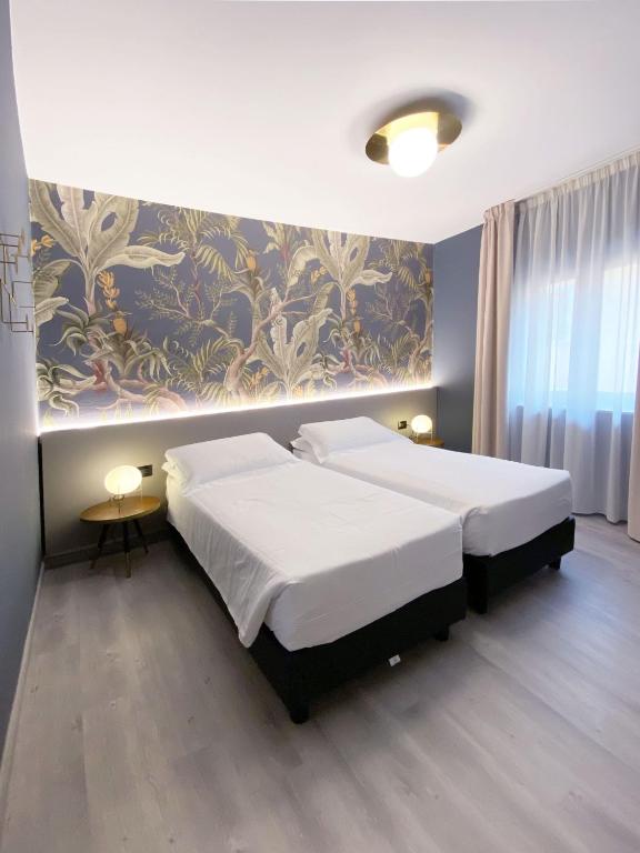 Postel nebo postele na pokoji v ubytování Hotel Astoria