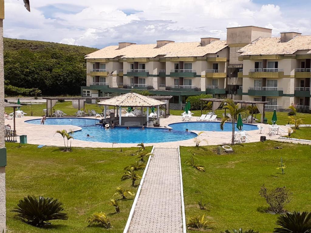an image of a resort with a swimming pool at Village Aldeia das águas 1° Andar in Nossa Senhora das Dores
