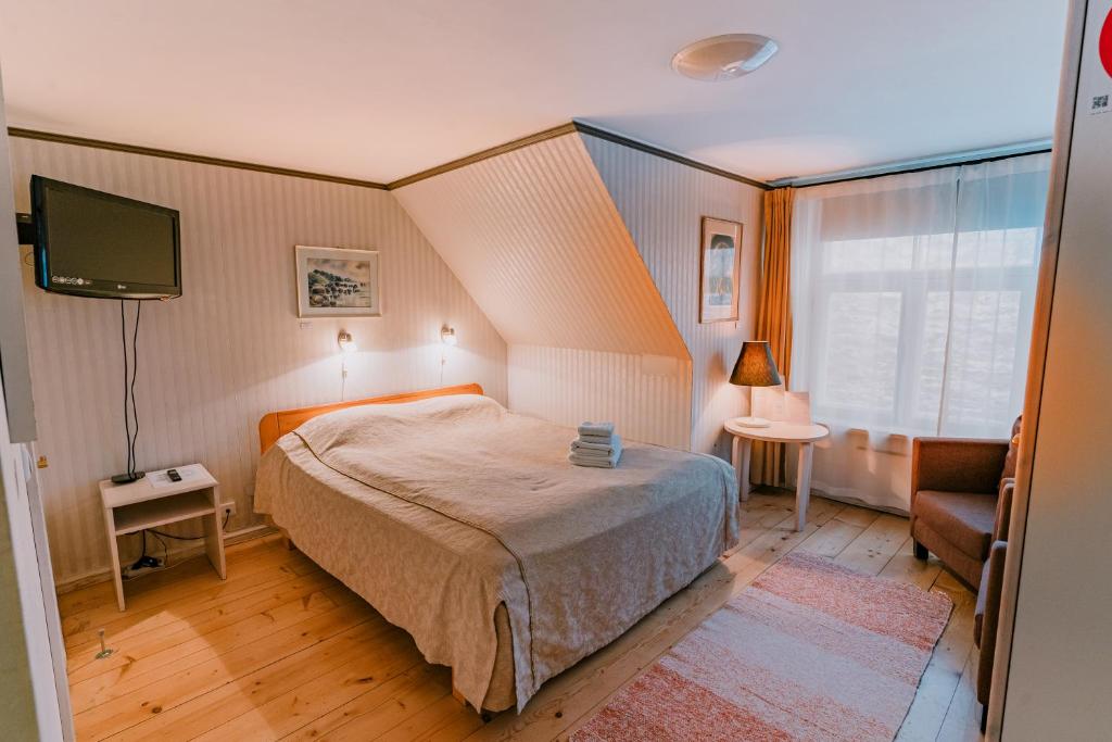 a small bedroom with a bed and a tv at Tampere Maja in Tartu