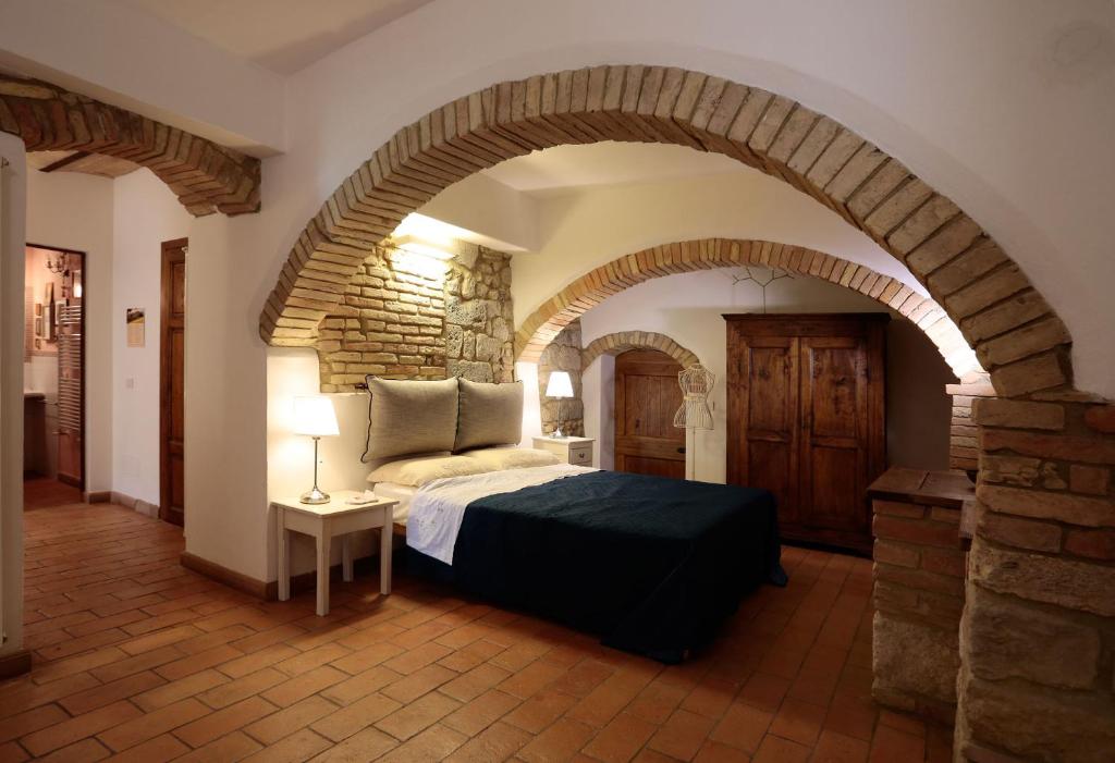 A bed or beds in a room at Corte dei Guelfi
