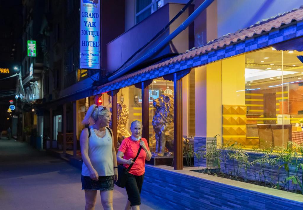 two women walking down a street in front of a store at Grand Yak Boutique Hotel in Kathmandu