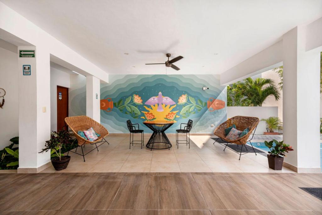 a living room filled with lots of furniture at Vela's Condos Ocean Front in Puerto Morelos