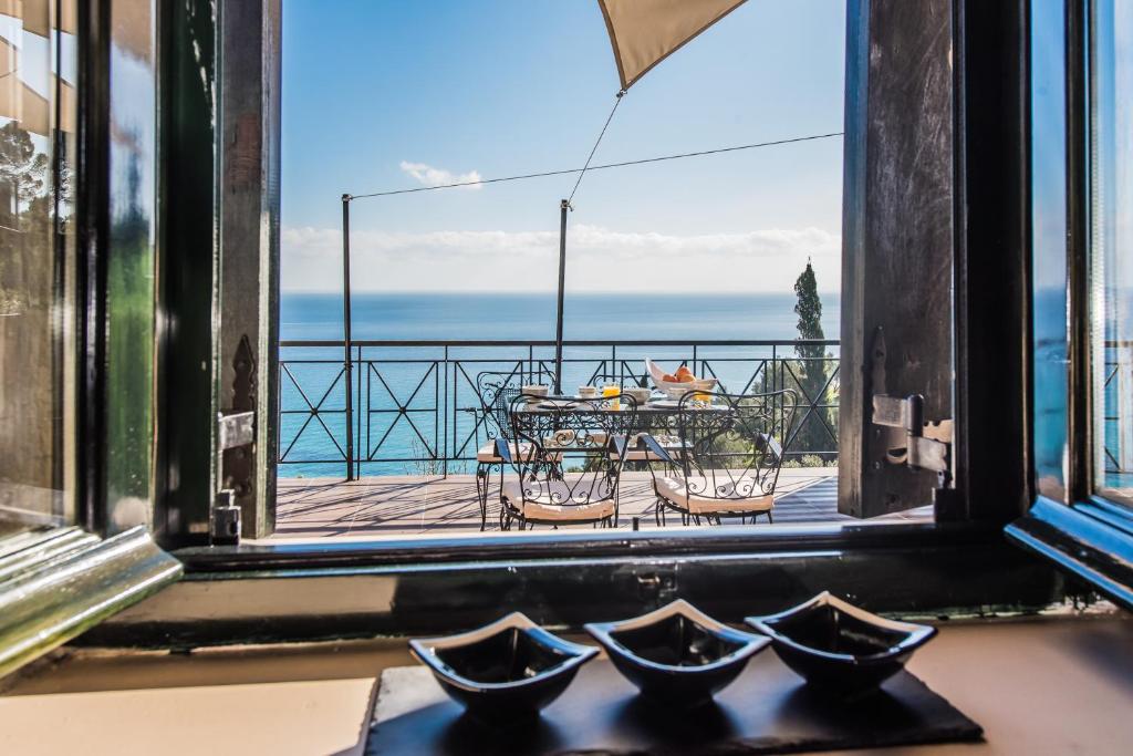 a view of a table and chairs from a window at Xigia Escape villas in Khartáta