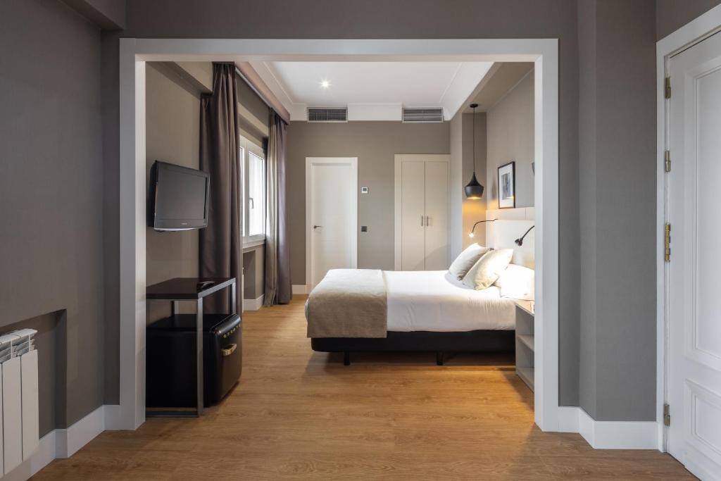 Postel nebo postele na pokoji v ubytování Hotel Cortezo