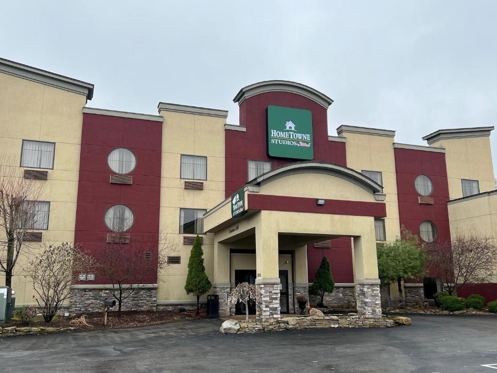 a hotel with a sign on the front of it at HomeTowne Studios & Suites Washington in Washington