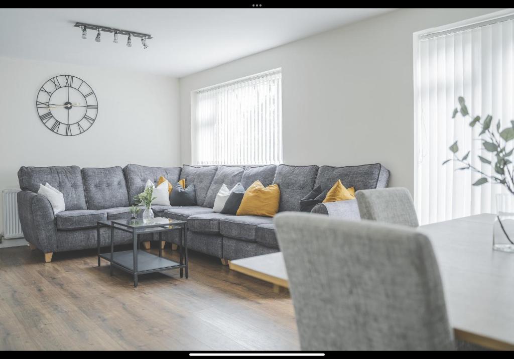 a living room with a gray couch and a table at The Whetstone in Birmingham