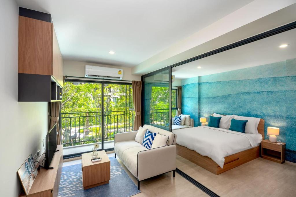 a bedroom with a large bed and a couch at Lacasita Near Beach Huahin (Room21) in Hua Hin