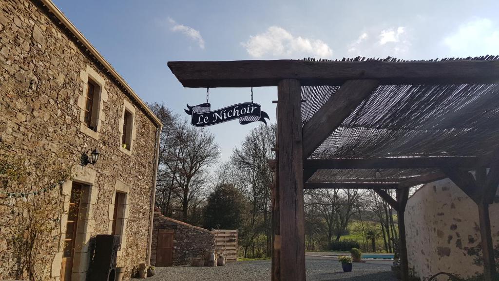 a sign for an entrance to a building at Le Nichoir in Les Essarts