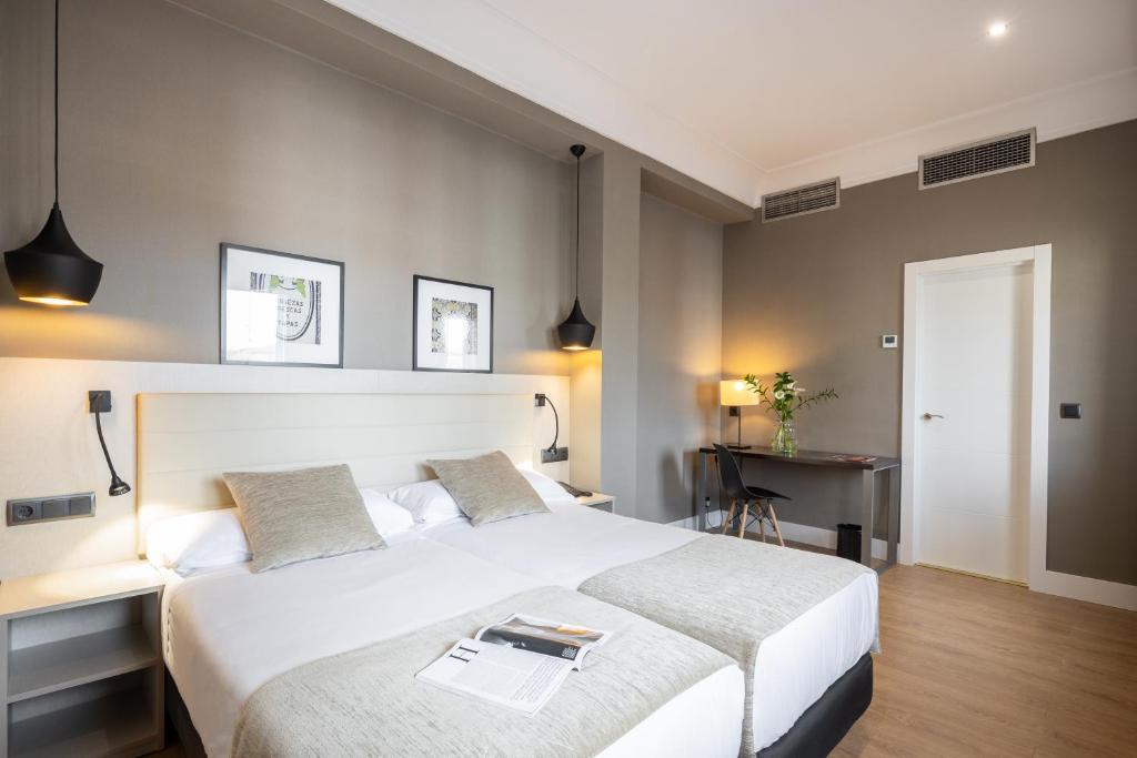 Postel nebo postele na pokoji v ubytování Hotel Cortezo