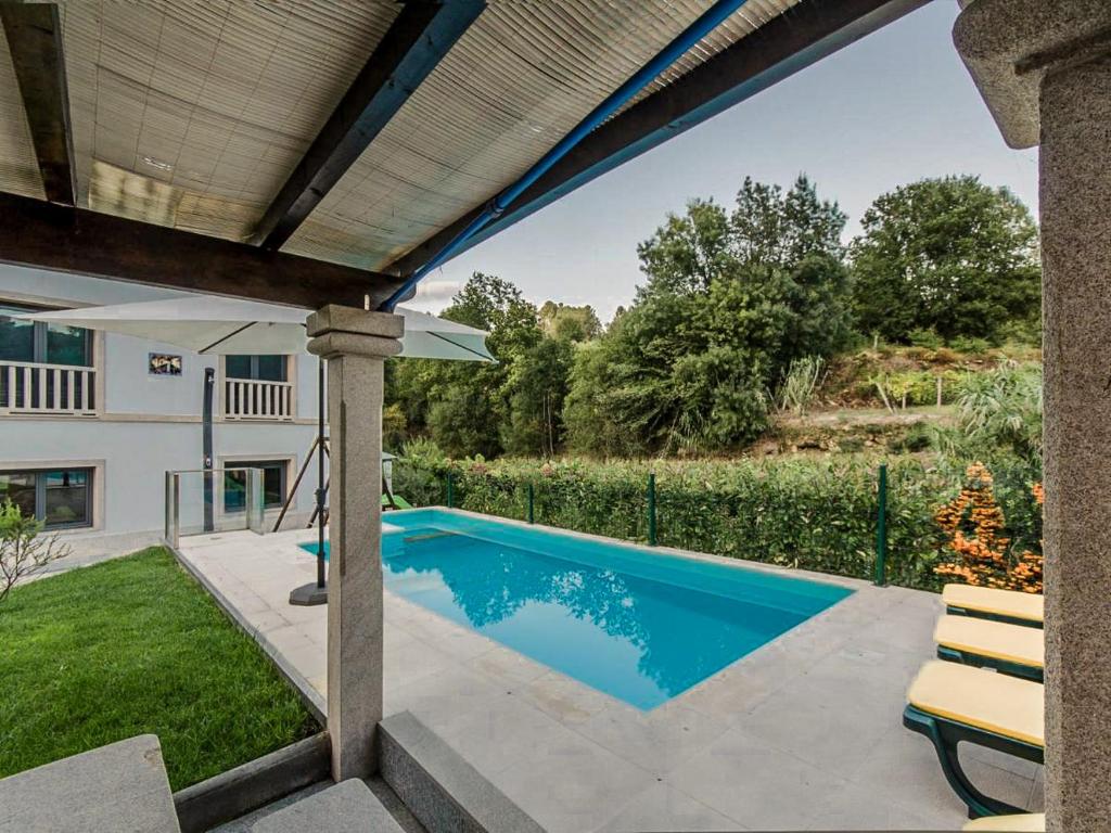 a swimming pool in the backyard of a house at Casa da Cevidade in Melgaço