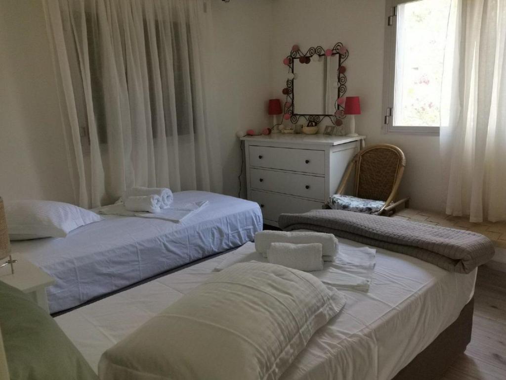Łóżko lub łóżka w pokoju w obiekcie VILLA ANDRIANA