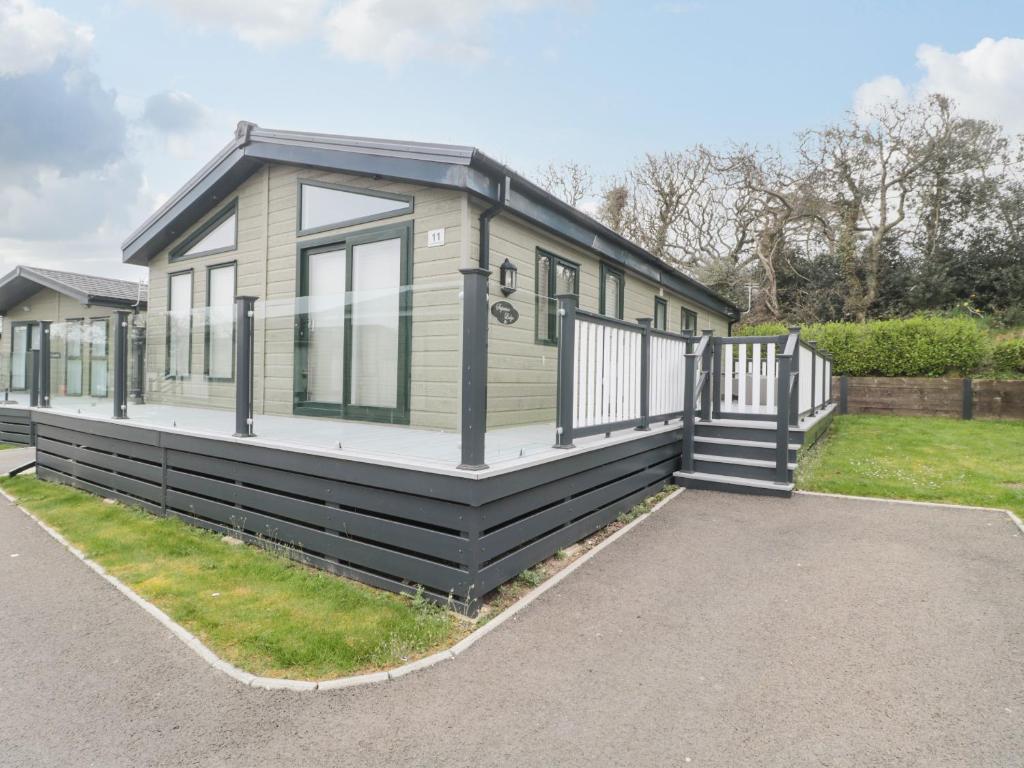 a tiny house with a black exterior at Amethyst Lodge in Lymington